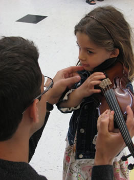 CUSO Concertmaster Daniel Sender coaches an eager violinist