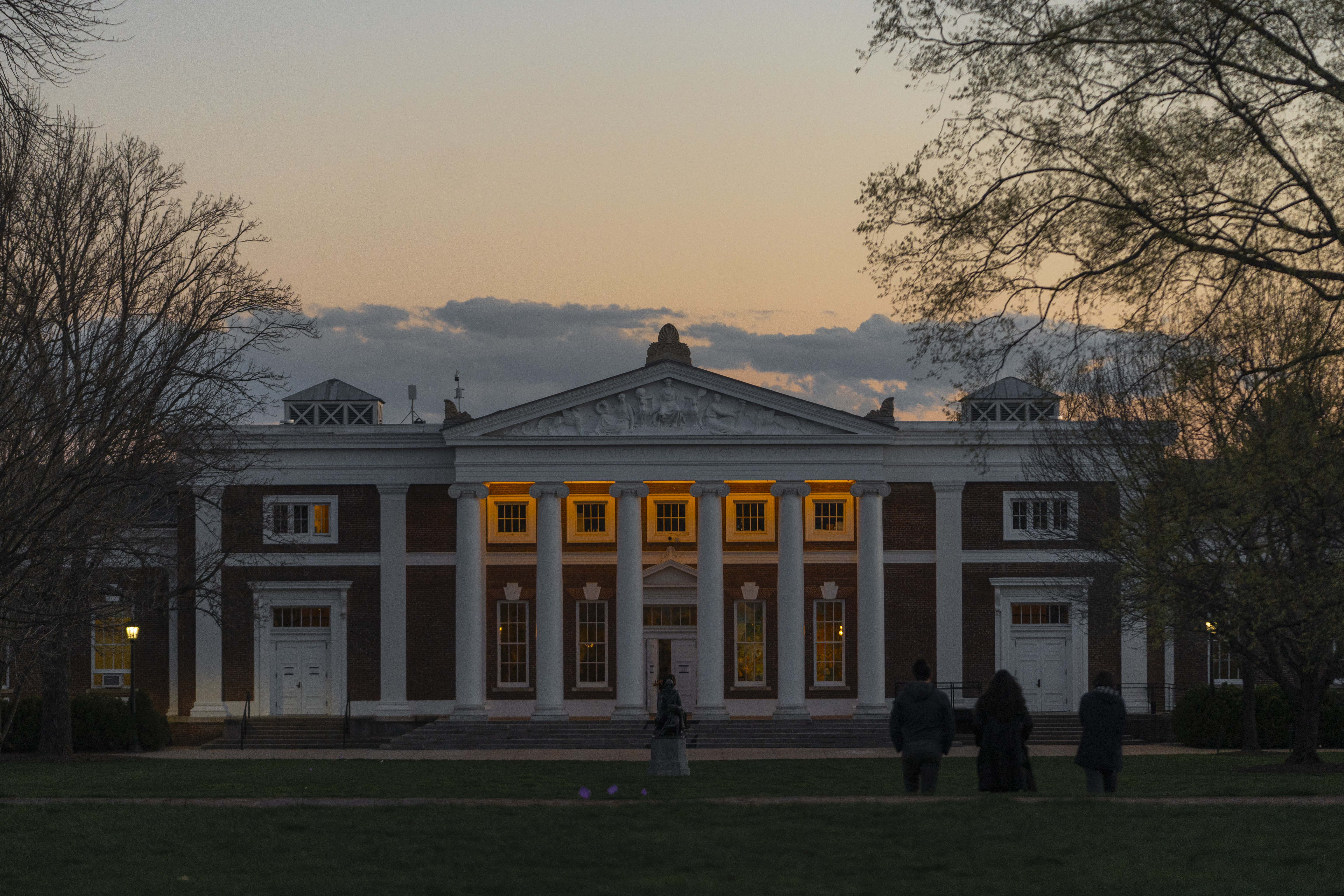 A view of the front entrance of Old Cabell Hall from the lawn at dusk
