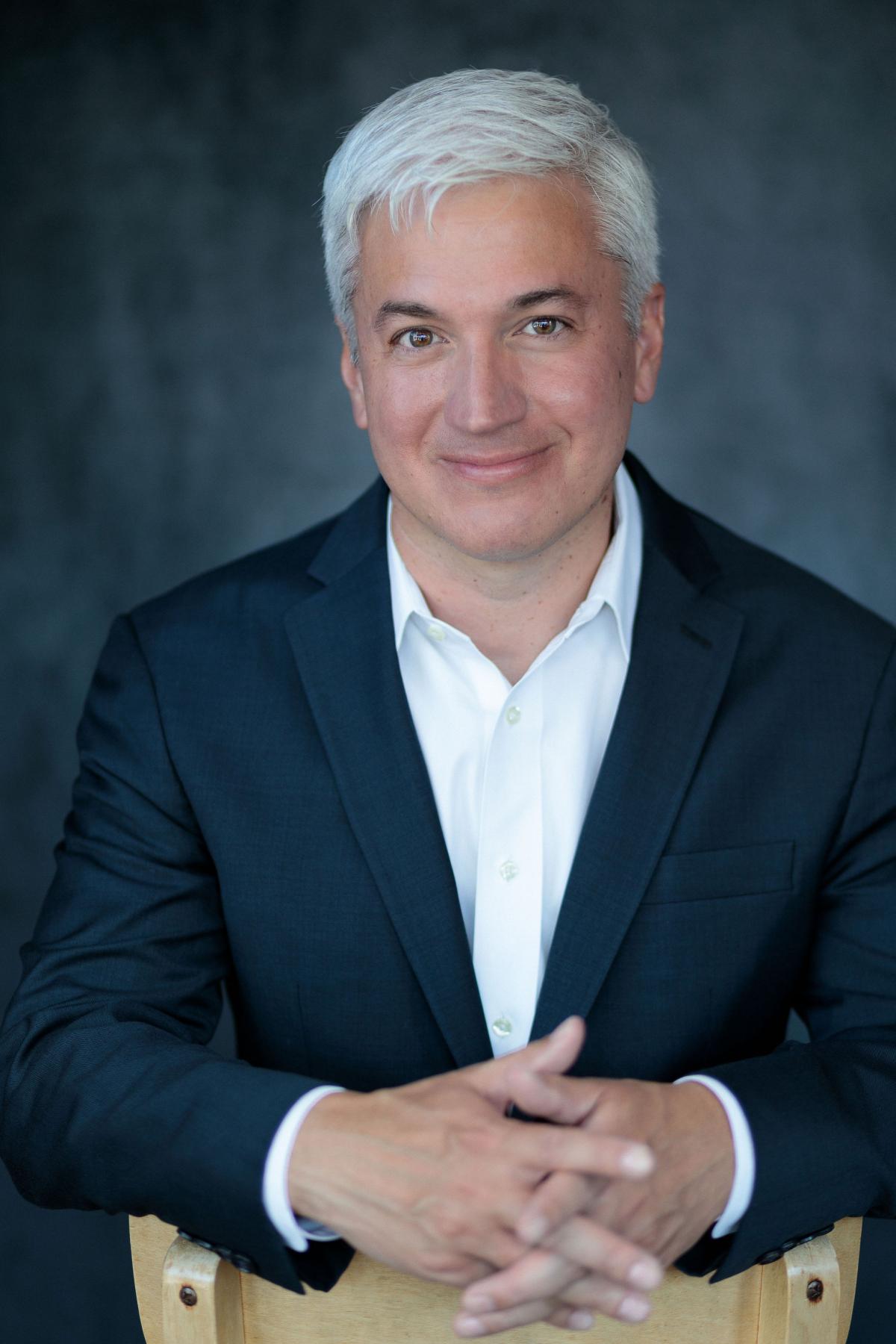 A headshot image of conductor Eric Garcia