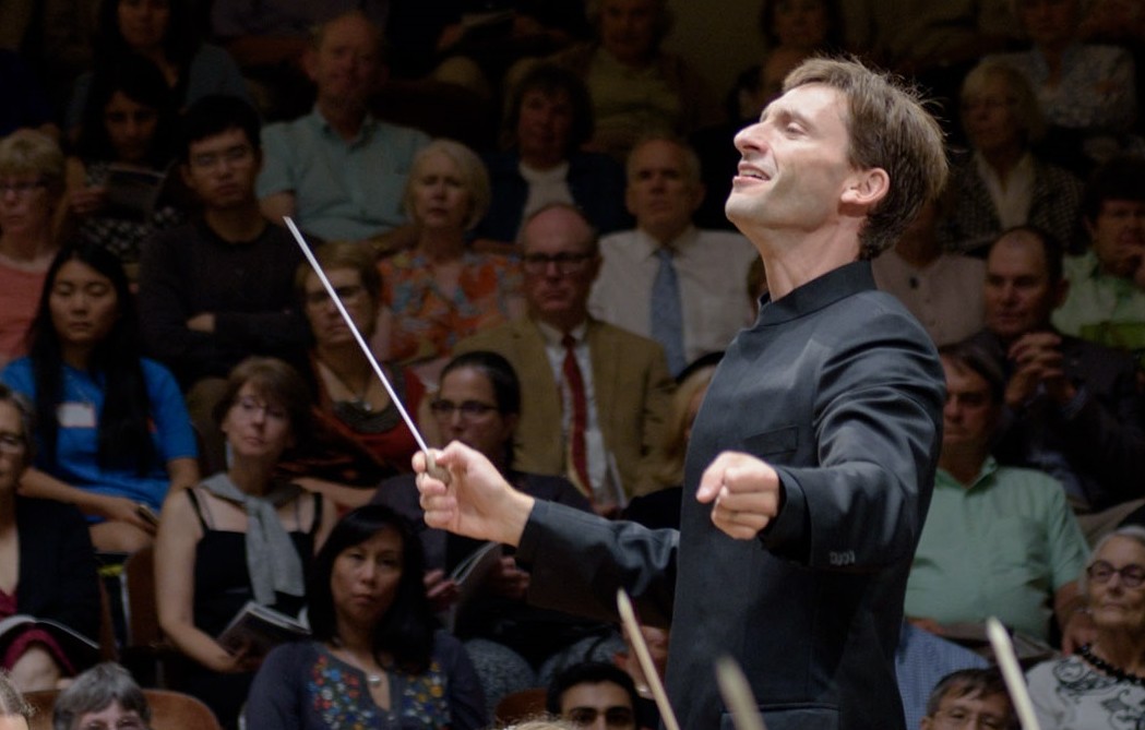 Ben Rous conducting, audience in background