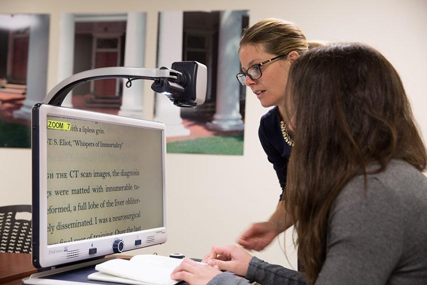 photo of student with computer screen with large type