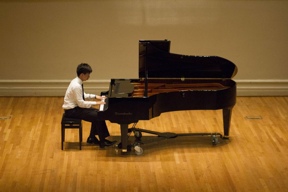 student pianist on stage in Old Cabell Hall