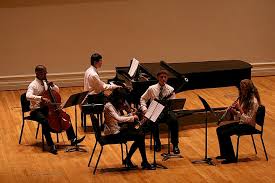 UVA students performing on the stage at Old Cabell Hall