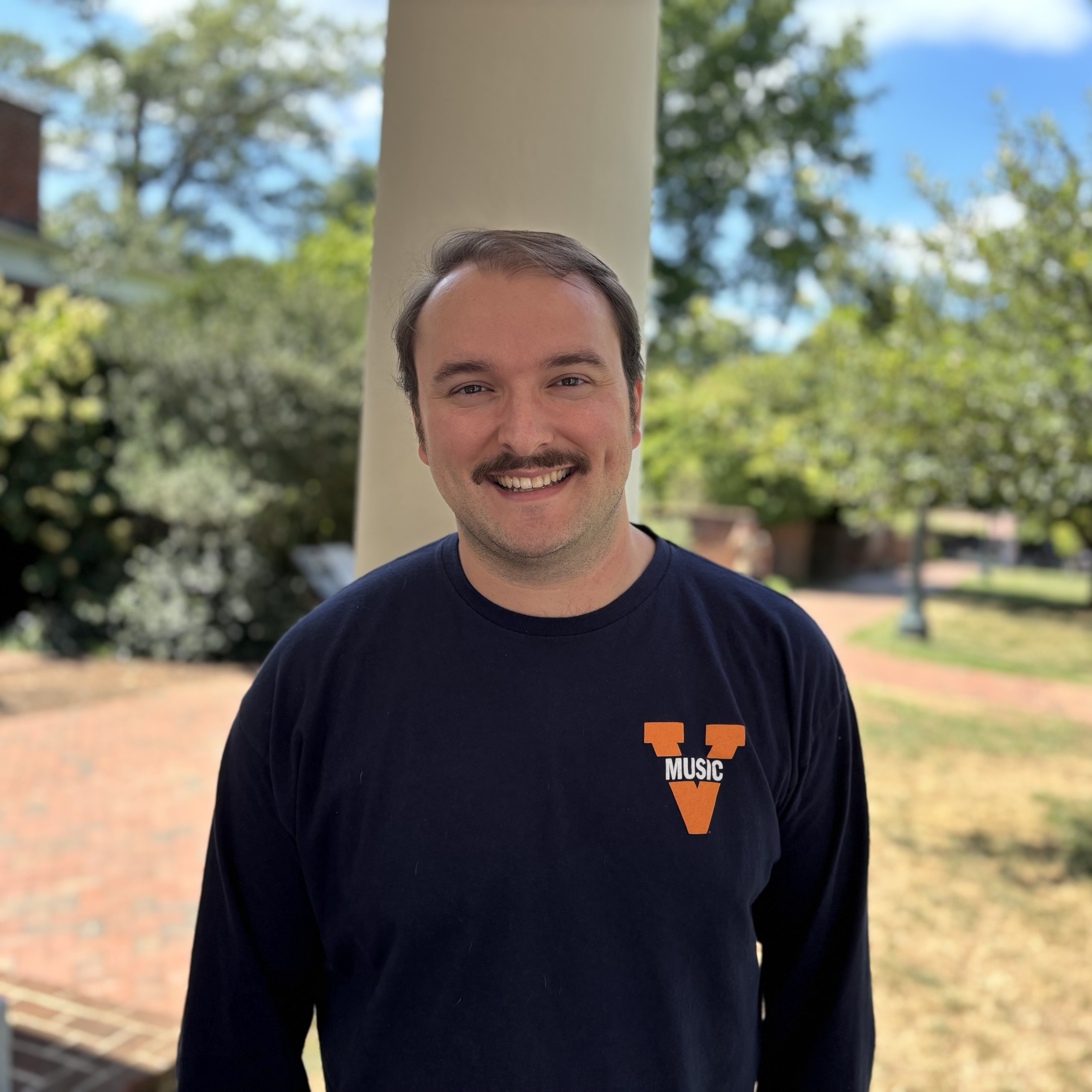 Staff member Michael Adkins standing outside of Rotunda building